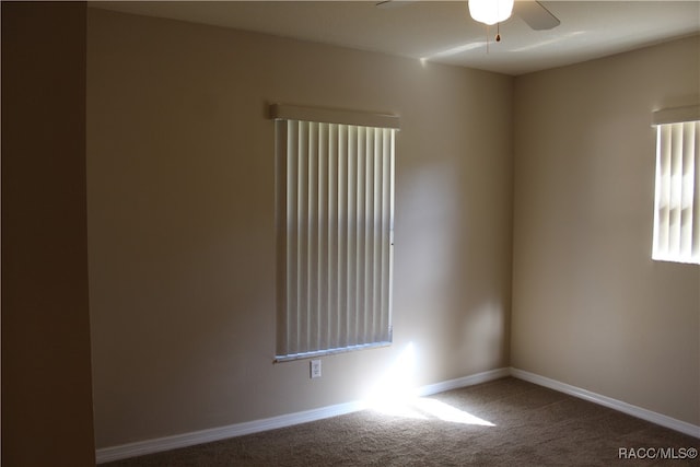 carpeted spare room featuring ceiling fan