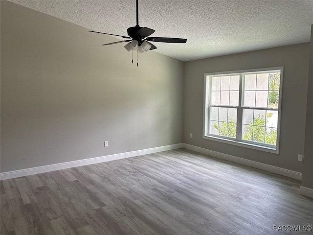 3289 W Camilo Dr, Dunnellon, FL 34433 - unfurnished room featuring a textured ceiling, wood finished floors, and ceiling fan