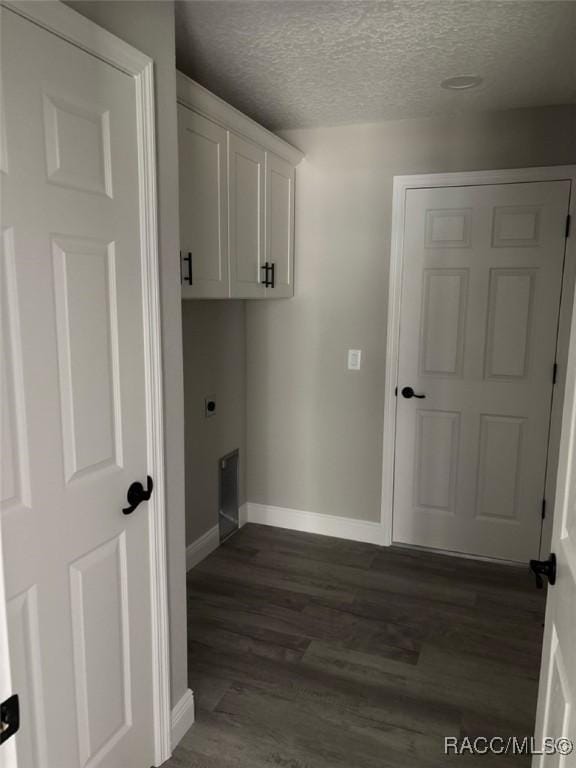 3289 W Camilo Dr, Dunnellon, FL 34433 - laundry area with dark wood-style floors, a textured ceiling, cabinet space, and electric dryer hookup