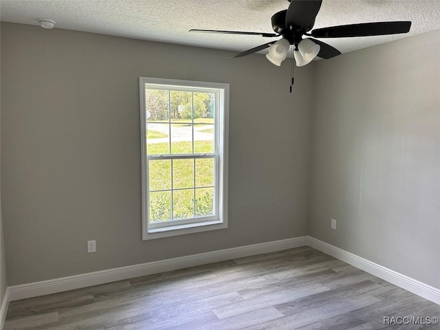 3289 W Camilo Dr, Dunnellon, FL 34433 - unfurnished room featuring a ceiling fan, plenty of natural light, wood finished floors, and a textured ceiling