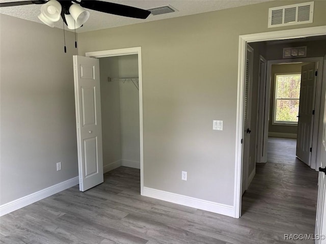 3289 W Camilo Dr, Dunnellon, FL 34433 - unfurnished bedroom with wood finished floors, a closet, and ceiling fan