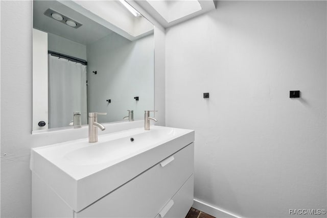 bathroom with vanity and a skylight