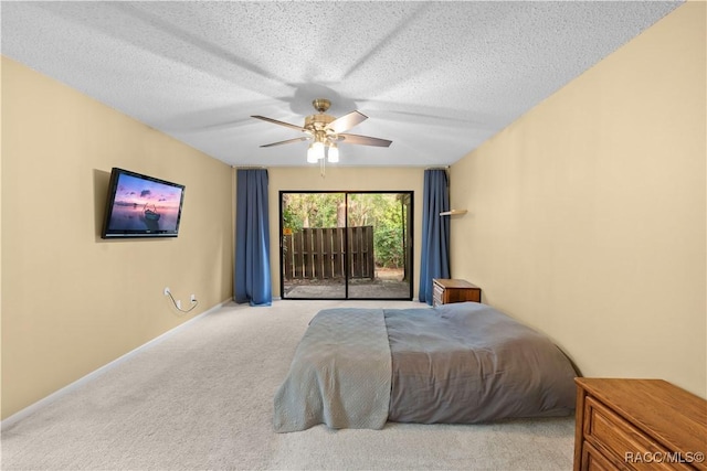 bedroom featuring light colored carpet, access to outside, a textured ceiling, and ceiling fan