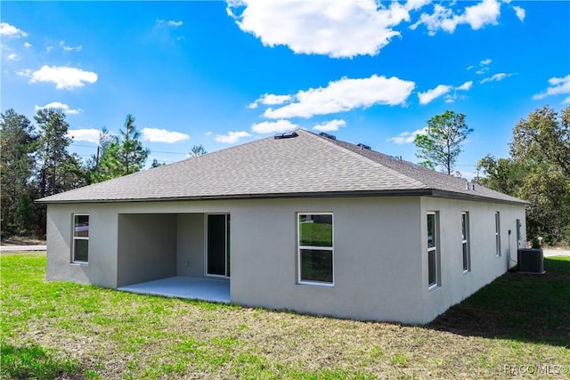 back of property featuring a yard, central AC unit, and a patio area