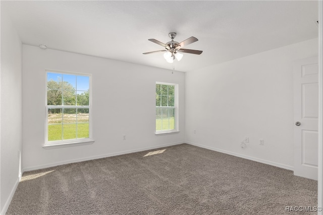 carpeted spare room with plenty of natural light and ceiling fan