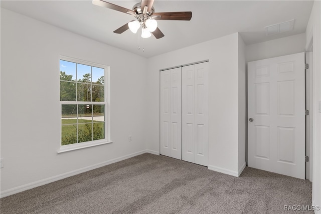 unfurnished bedroom featuring light carpet, a closet, and ceiling fan