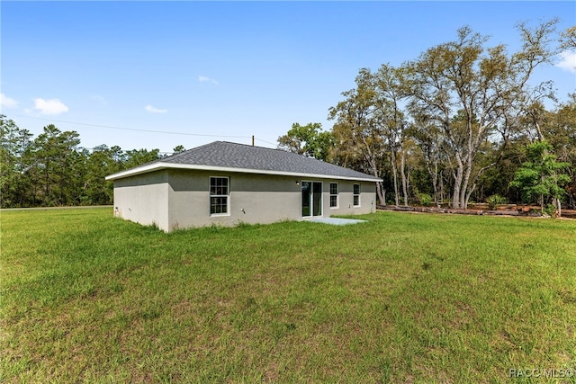 rear view of house with a yard