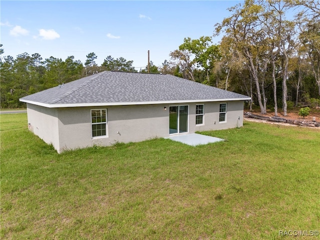 rear view of property with a yard