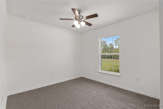 carpeted spare room with ceiling fan