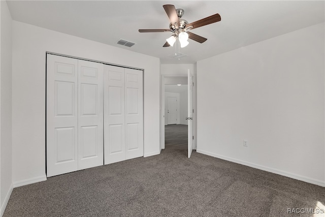 unfurnished bedroom with ceiling fan, a closet, and dark colored carpet