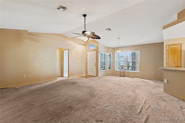 unfurnished living room featuring carpet, ceiling fan, a textured ceiling, and vaulted ceiling