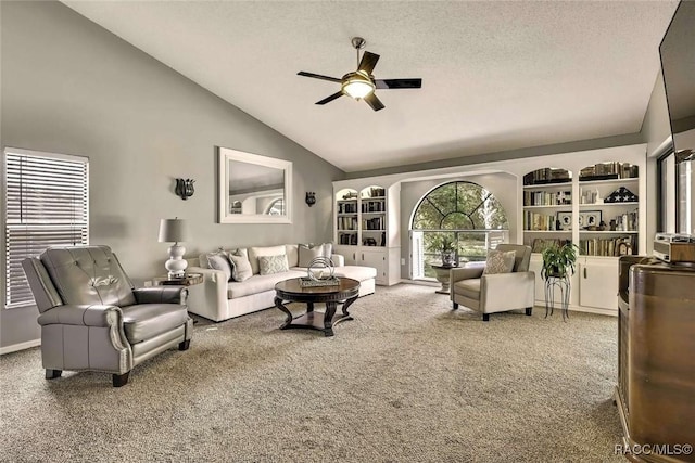 carpeted living area with high vaulted ceiling, a textured ceiling, and ceiling fan