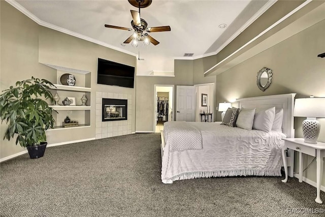 carpeted bedroom featuring visible vents, a tile fireplace, crown molding, and baseboards