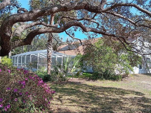 view of yard with glass enclosure