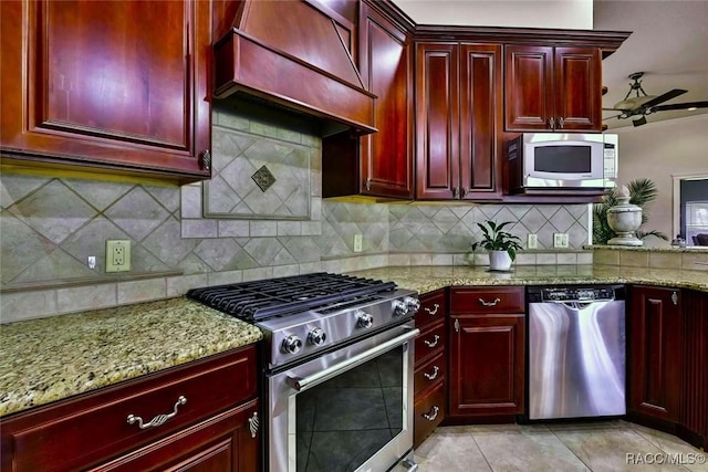 kitchen featuring custom exhaust hood, appliances with stainless steel finishes, and reddish brown cabinets