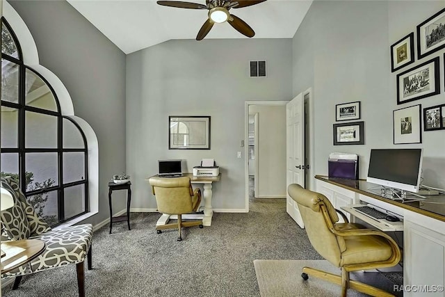 carpeted home office featuring visible vents, ceiling fan, high vaulted ceiling, and baseboards