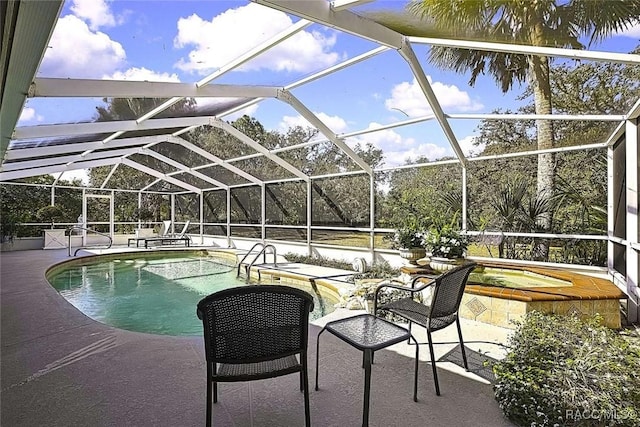 pool with a hot tub, a lanai, and a patio area