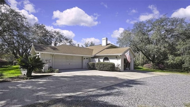 view of front facade featuring a garage, concrete driveway, a chimney, and stucco siding