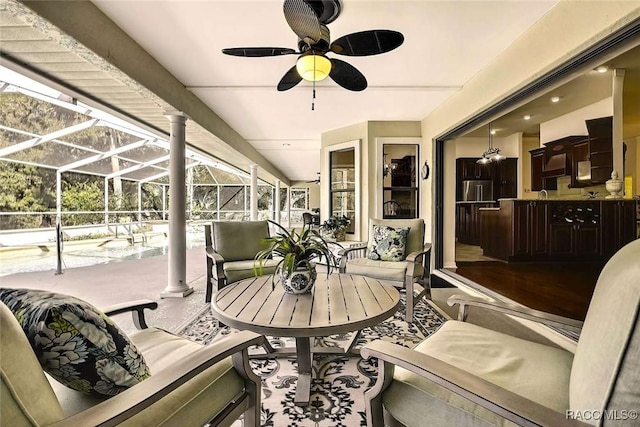 sunroom with a healthy amount of sunlight and ceiling fan