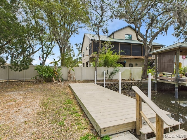 view of dock with a fenced backyard and a wooden deck