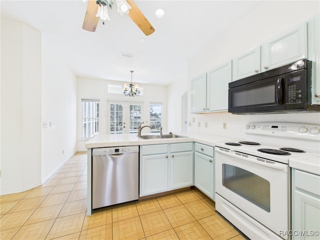kitchen featuring electric range, black microwave, dishwasher, a sink, and a peninsula