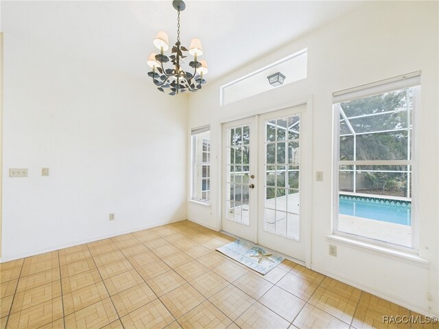 402 NW Magnolia Cir, Crystal River, FL 34428 - entryway featuring a chandelier, french doors, and baseboards