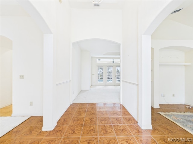 corridor featuring arched walkways