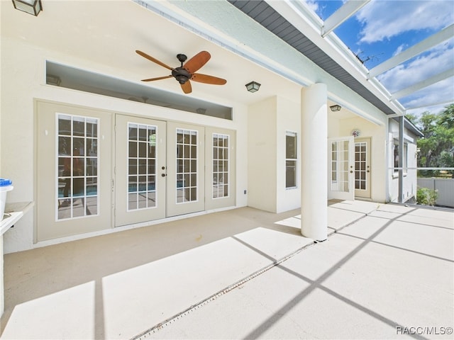 view of patio / terrace featuring french doors, a ceiling fan, and a lanai