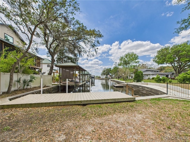 dock area with a water view and fence