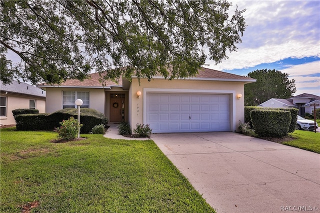 ranch-style home featuring a garage and a front lawn