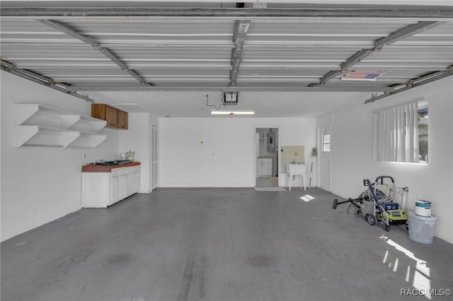 garage with a sink and a garage door opener