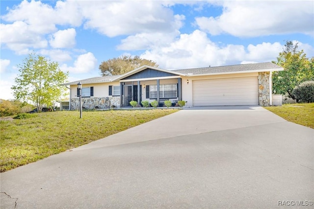 ranch-style home with driveway, stucco siding, a front lawn, a garage, and stone siding