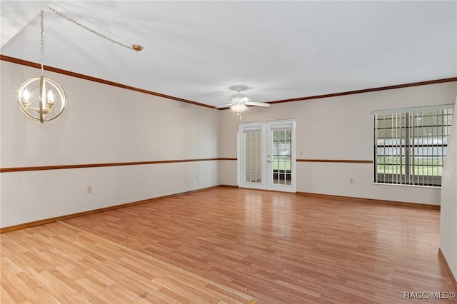 unfurnished room with ceiling fan with notable chandelier, light wood-type flooring, crown molding, and french doors