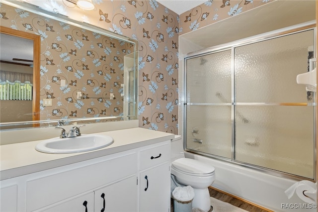 full bathroom featuring vanity, toilet, enclosed tub / shower combo, and wood-type flooring