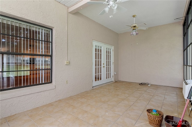 unfurnished sunroom featuring french doors, vaulted ceiling with beams, and ceiling fan