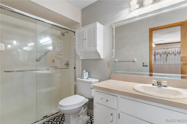 bathroom with toilet, vanity, a textured ceiling, and walk in shower