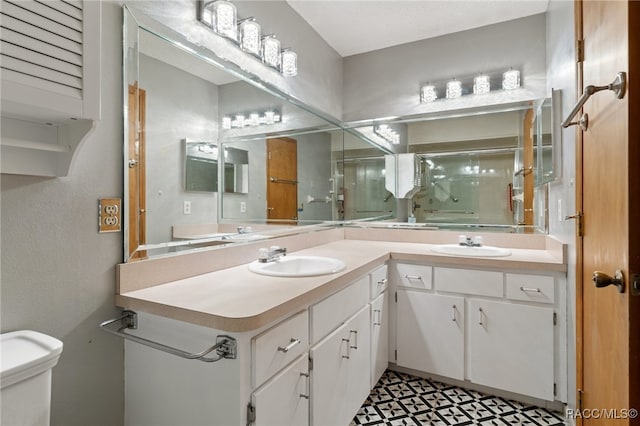 bathroom with walk in shower, vanity, and toilet