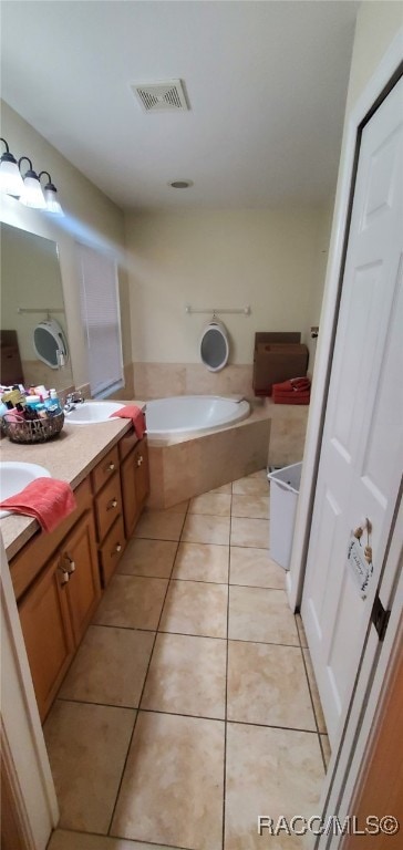 7689 N Galt Pt, Citrus Springs, FL 34434 - bathroom with double vanity, a garden tub, and tile patterned flooring