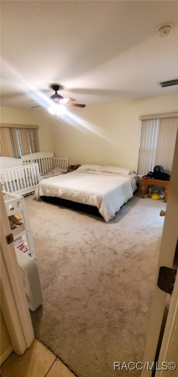 7689 N Galt Pt, Citrus Springs, FL 34434 - bedroom with light carpet and ceiling fan