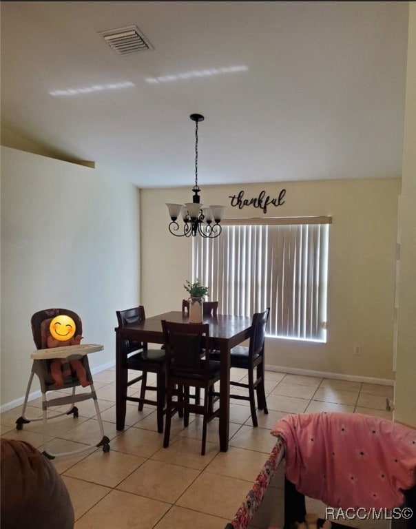 7689 N Galt Pt, Citrus Springs, FL 34434 - dining space with a chandelier and light tile patterned floors