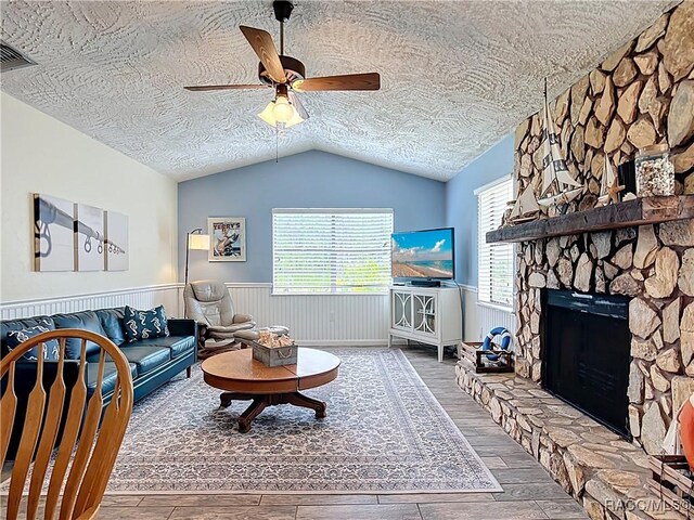 857 N Palm Springs Ter, Crystal River, FL 34429 - living room with vaulted ceiling, wood finished floors, a textured ceiling, a wainscoted wall, and ceiling fan