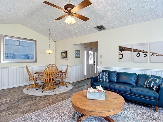 857 N Palm Springs Ter, Crystal River, FL 34429 - living room featuring wood finished floors, a textured ceiling, lofted ceiling, wainscoting, and ceiling fan