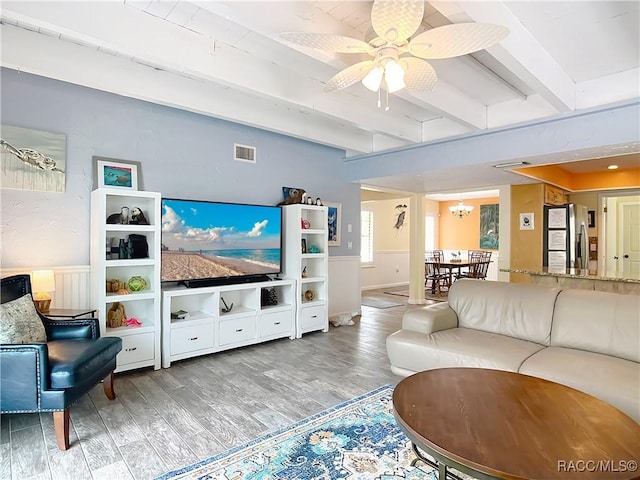 857 N Palm Springs Ter, Crystal River, FL 34429 - living room featuring beam ceiling, wood finished floors, ceiling fan, a chandelier, and wainscoting