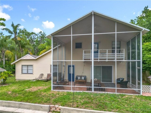 857 N Palm Springs Ter, Crystal River, FL 34429 - back of house with a balcony, a yard, and a sunroom
