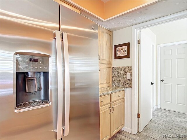 857 N Palm Springs Ter, Crystal River, FL 34429 - kitchen with stainless steel refrigerator with ice dispenser, light brown cabinets, light wood-type flooring, and light stone counters