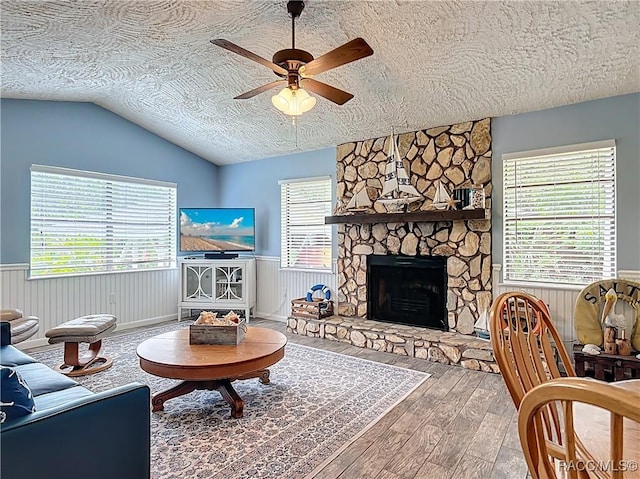857 N Palm Springs Ter, Crystal River, FL 34429 - living room featuring a ceiling fan, hardwood / wood-style floors, a textured ceiling, a wainscoted wall, and lofted ceiling