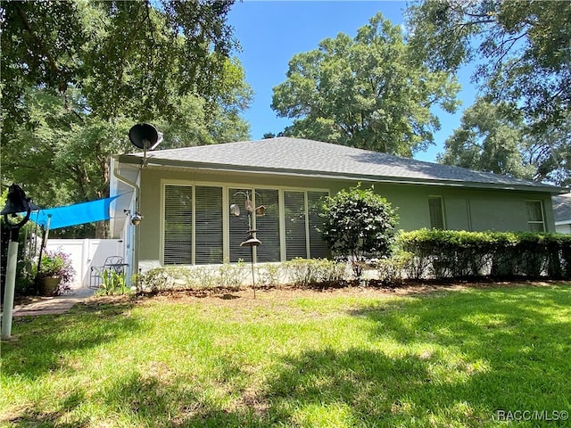 rear view of property with a yard