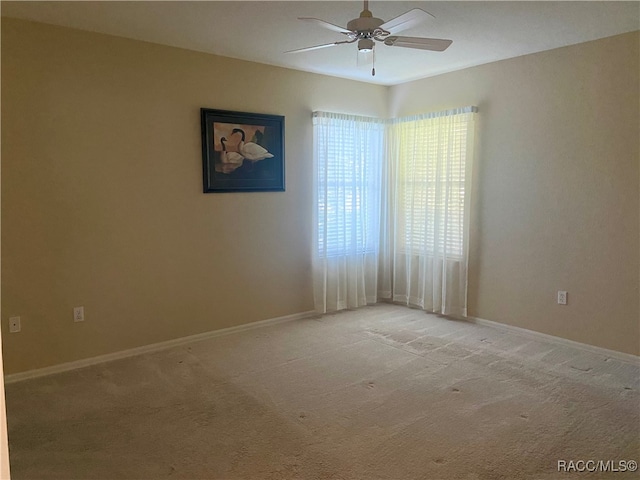 carpeted empty room featuring ceiling fan