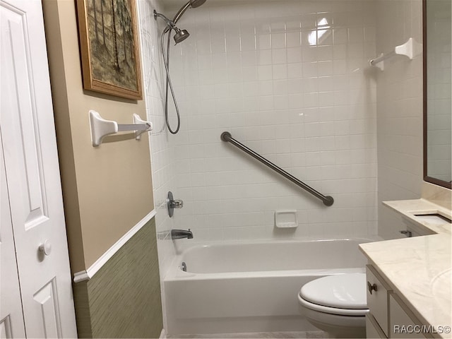 full bathroom with vanity, toilet, and tiled shower / bath