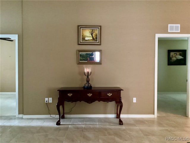 hall with light tile patterned flooring